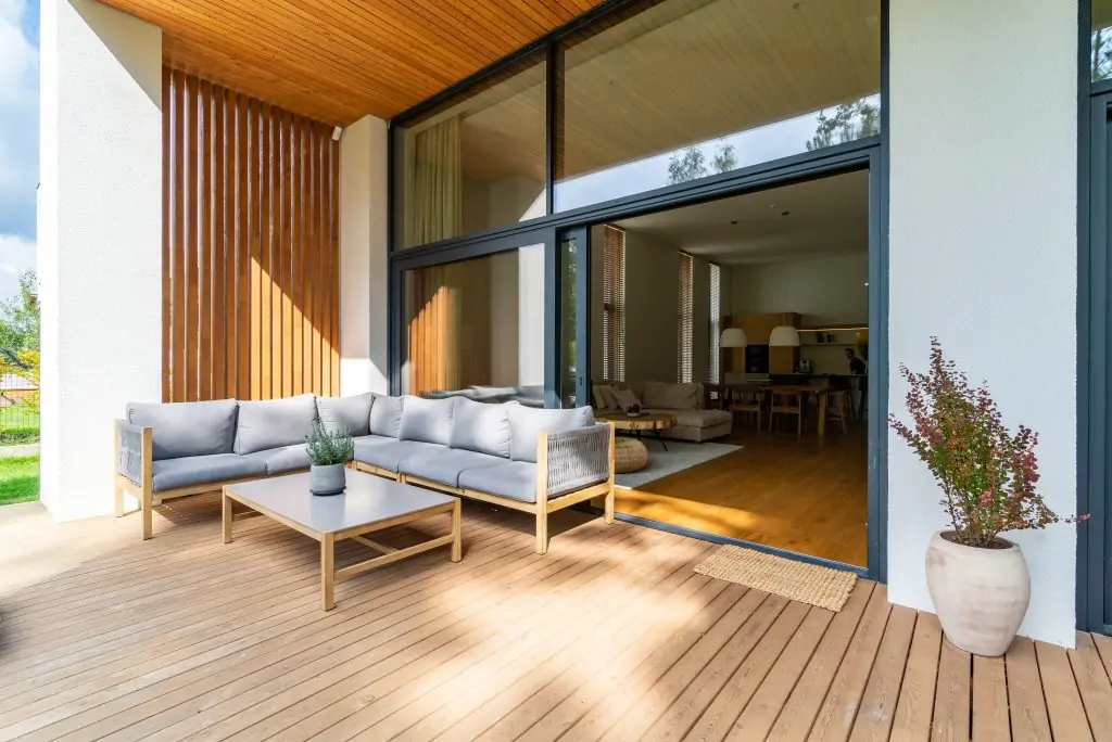 A cozy outdoor deck can brighten up the entrance to any home.
