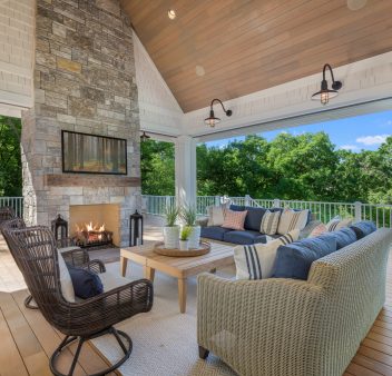 A luxury outdoor area including an outdoor fireplace.